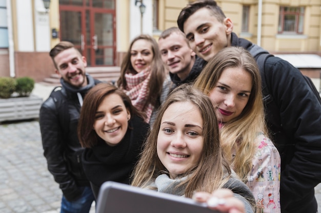 Free photo friends taking selfie on street