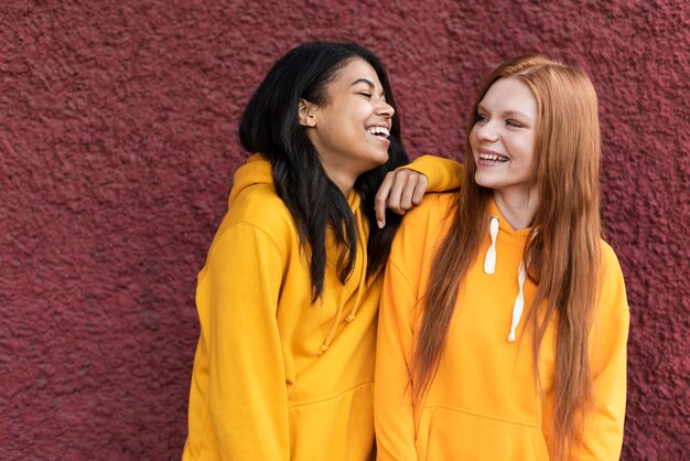 Friends talking while wearing yellow hoodies