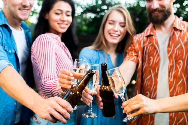 Friends toasting drinks together outdoors