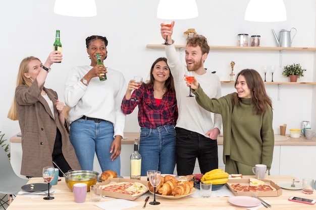 Free photo friends toasting during lunch