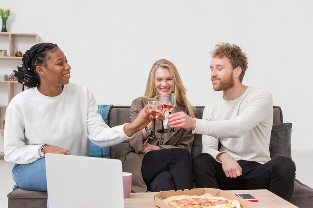 Friends toasting while eating