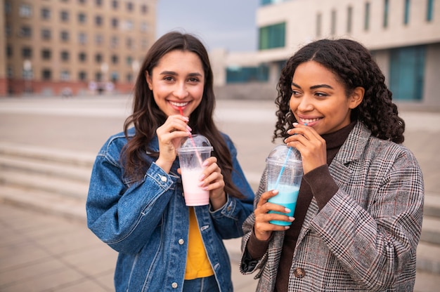 Friends together outdoors with milkshakes