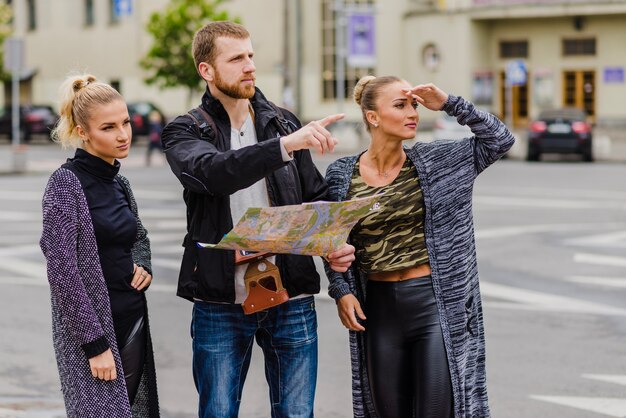 Friends travelling and navigating with map