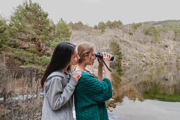 Friends using binoculars outdoors