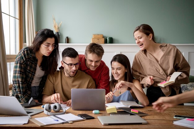 Friends using a laptop to learn during study session