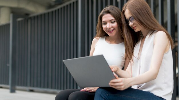 Friends using the laptop together