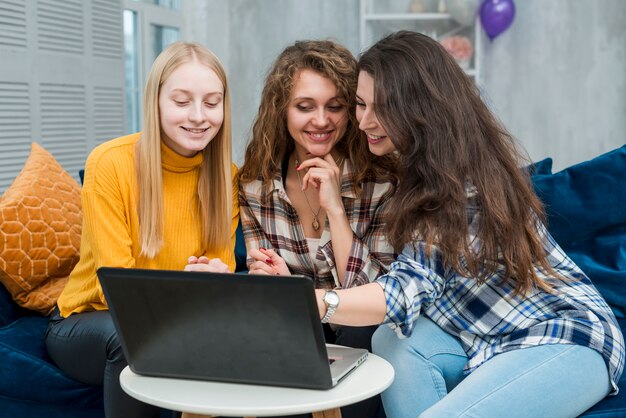 Friends using laptop