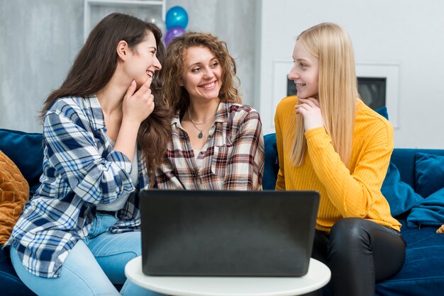 Friends using laptop