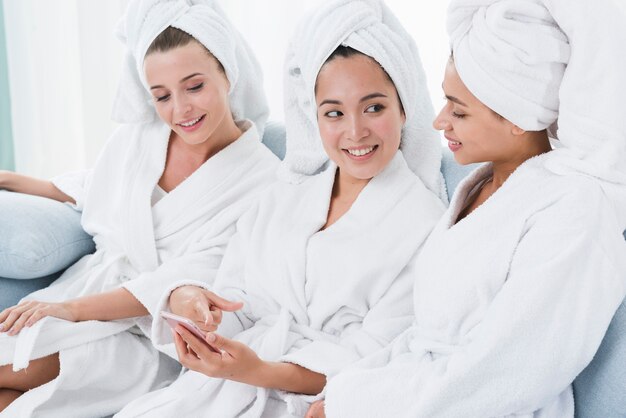 Friends using a mobile in a spa