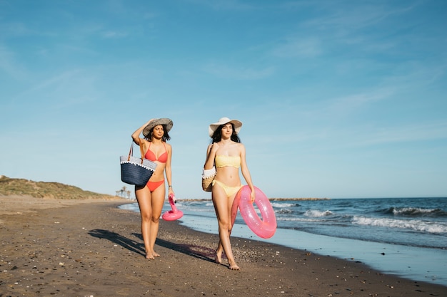 Friends walking at the shoreline