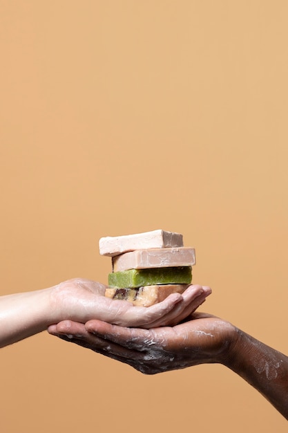 Free photo friends washing hands with soap