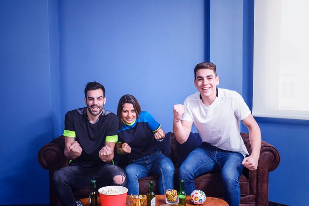 Friends watching football in living room