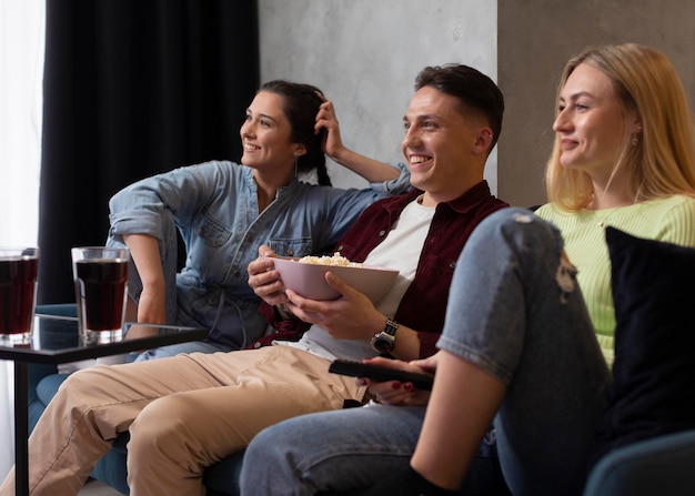 Free photo friends watching streaming service together indoors