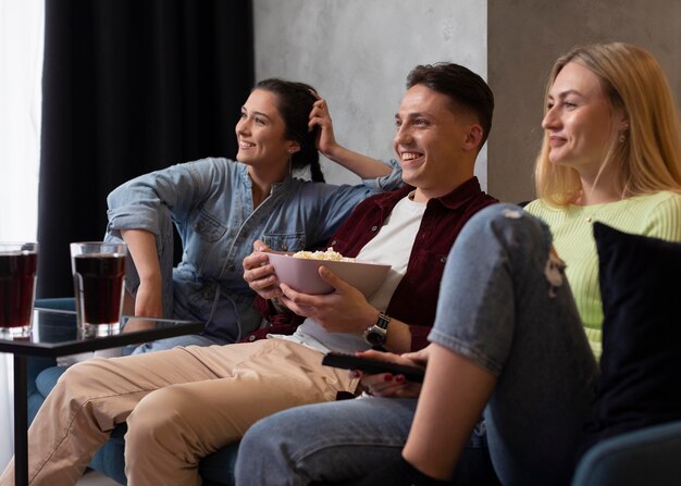 Friends watching streaming service together indoors