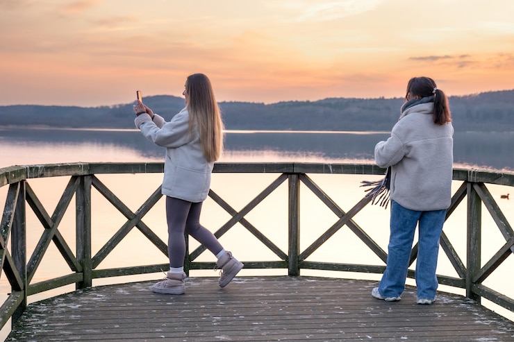 Free Photo friends watching the sunset on the lake sunset walking in nature pier berth