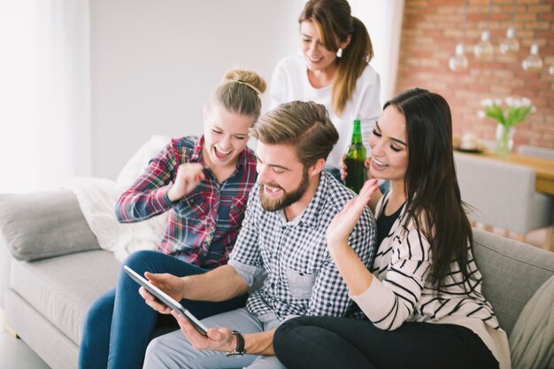 Friends watching tablet happy with winning