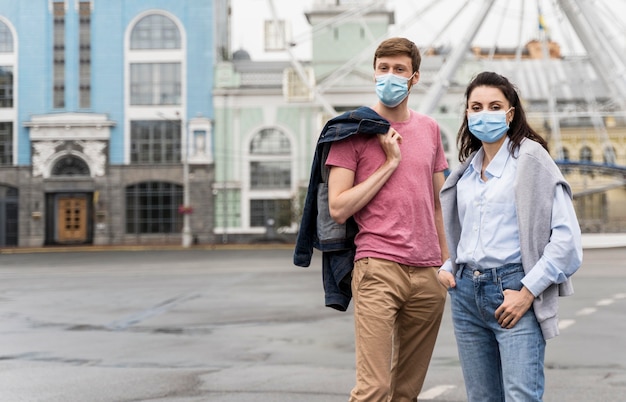 Free photo friends wearing face masks with copy space