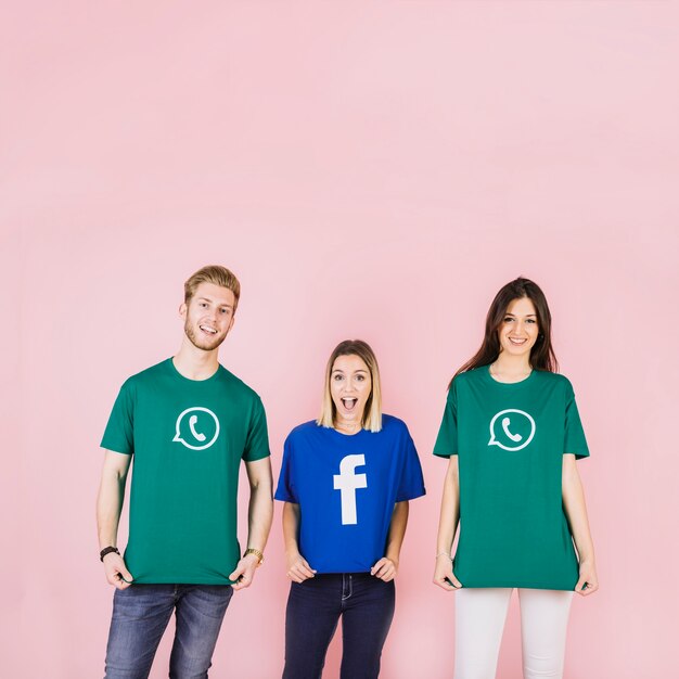 Friends wearing social media icon t-shirt on pink backdrop