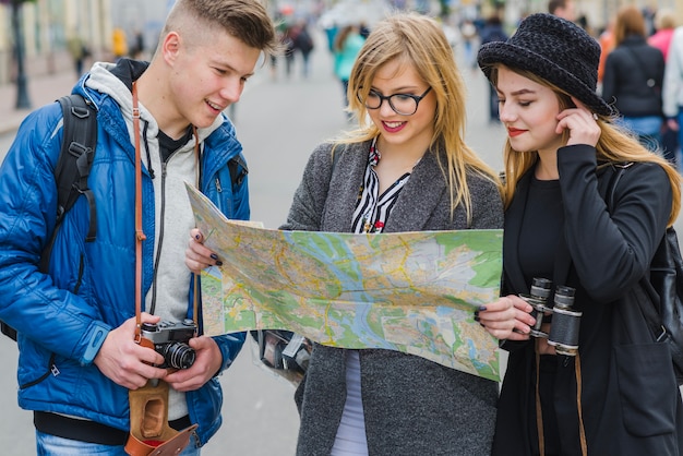 Friends with map on street