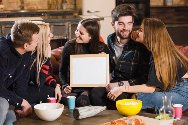 Friends with whiteboard at a party