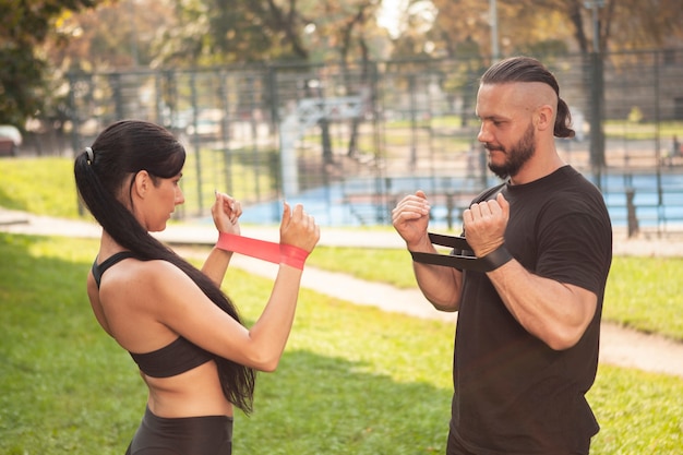 Friends working out with rubber band for hands