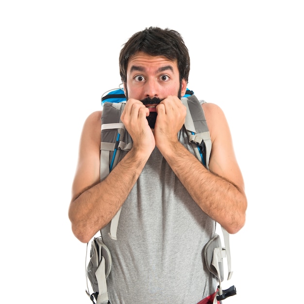 Frightened backpacker over isolated white background