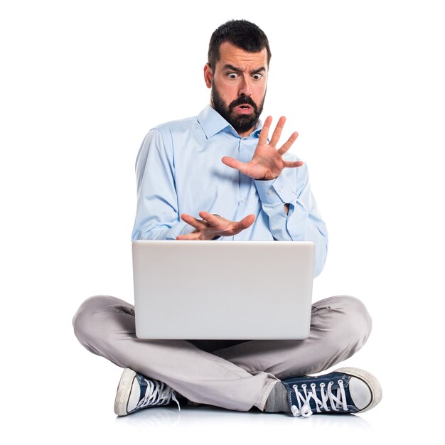 Frightened man with laptop