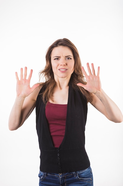 Frightened woman defending herself against white background