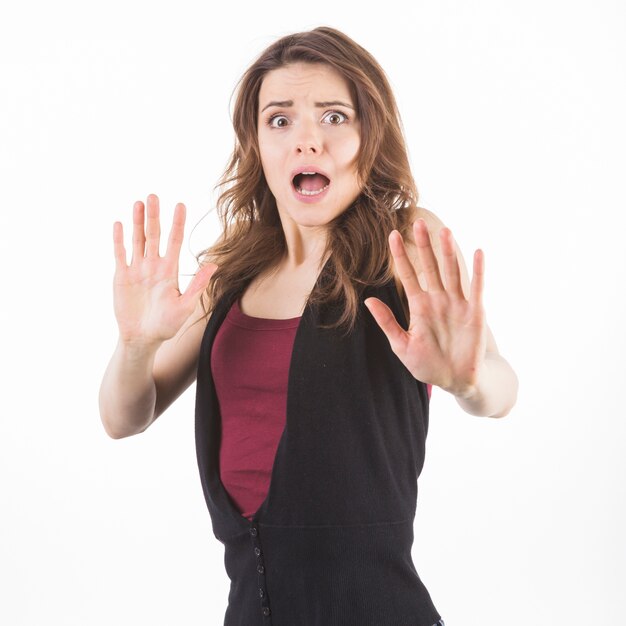 Frightened woman defending herself against white background
