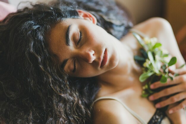 From abbove woman sleeping with flowers