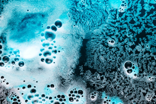 From above blue foam on dark water