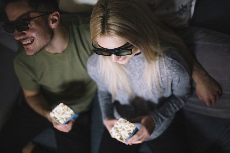 Free Photo from above couple watching film