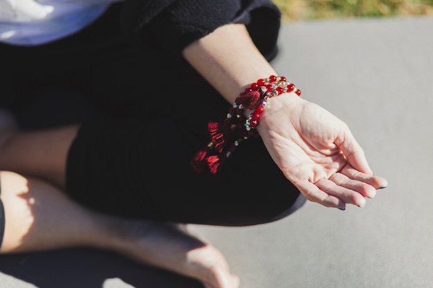 From above hand of meditating woman