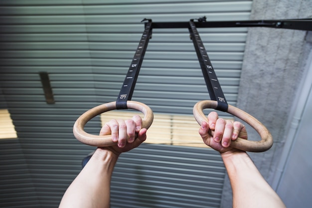 Free photo from below hands on gymnastic rings