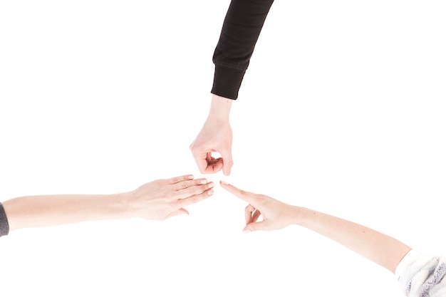 From above hands playing rock-paper scissors