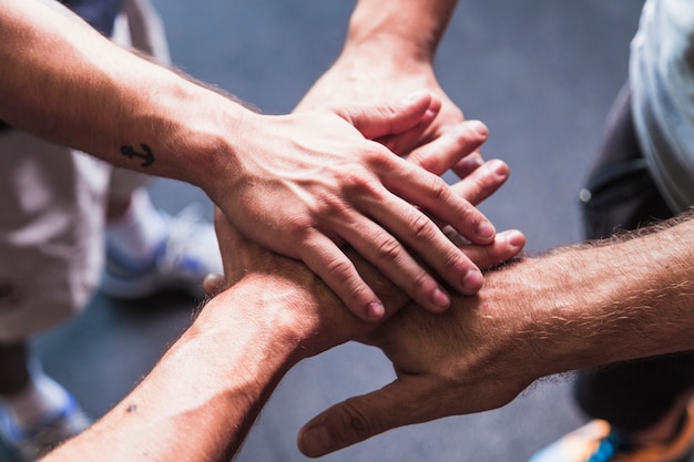 From above men holding hands together