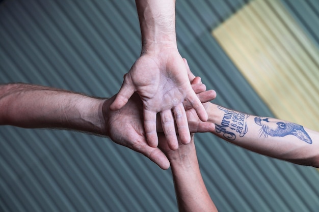 Free photo from below men holding hands together