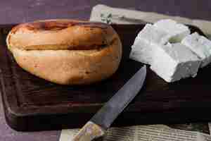 Free photo from above pogaca with cheese and knife in cutting board