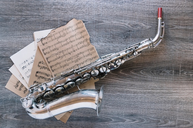 Free photo from above sheet music under saxophone