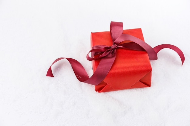 Free photo from above shot of bright giftboxes decorated with ribbon laying on white snow