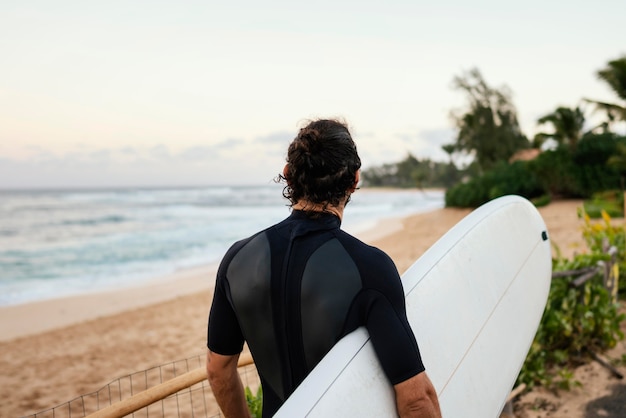 From behind shot surfer man outdoors