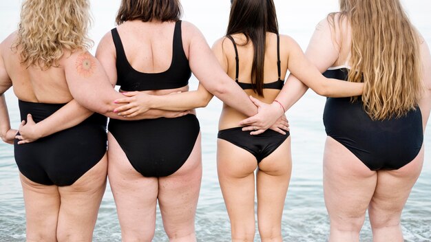 from behind shot women holding hands