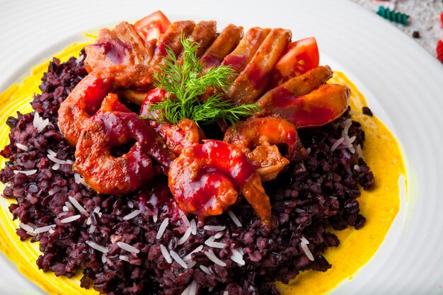 From above shrimps in batter with red rice and greens in white plate