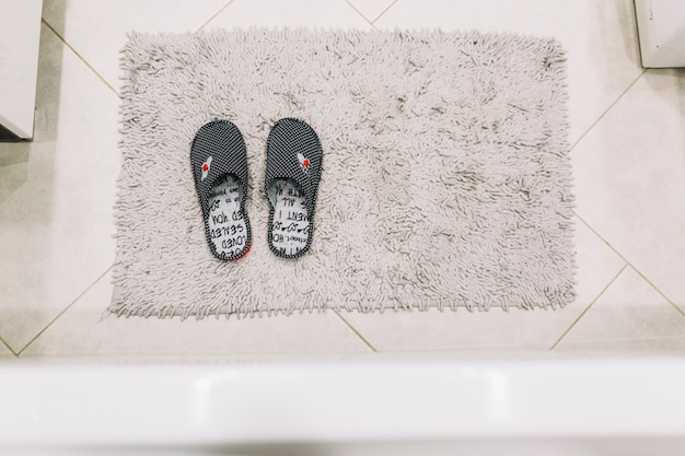 Free photo from above slippers on shaggy rag