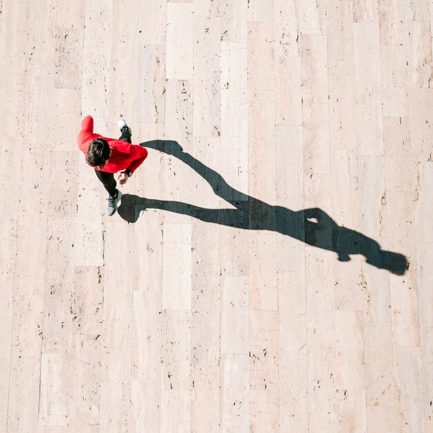 From above sportsman running on sunny day