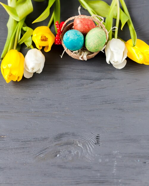 From above tulips and basket with eggs