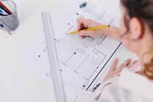 Free photo from above woman drawing blueprint