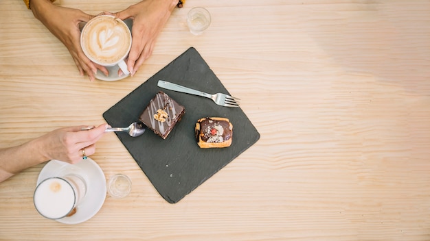 From above women with dessert and coffee