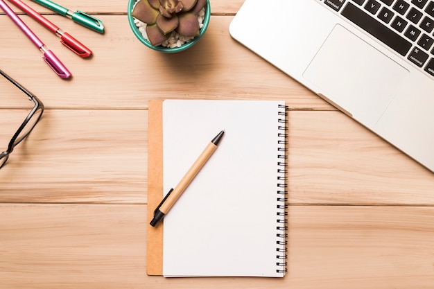 Free photo from above of workspace with notebook and laptop