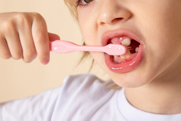 Прелестный вид крупным планом вид спереди белокурый мальчик мило прелестный очистки его зубы